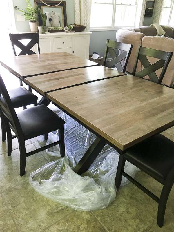 How to affordably update your home decor with a DIY tutorial! Learn how to strip and refinish a wood dining table for a modern farmhouse style makeover.