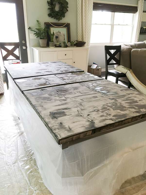 How to affordably update your home decor with a DIY tutorial! Learn how to strip and refinish a wood dining table for a modern farmhouse style makeover.