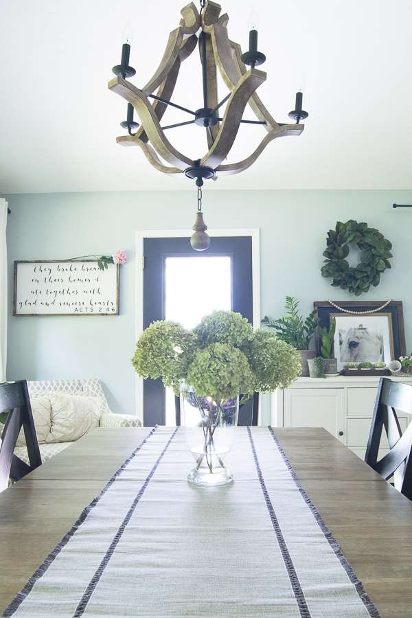 How to affordably update your home decor with a DIY tutorial! Learn how to strip and refinish a wood dining table for a modern farmhouse style makeover.