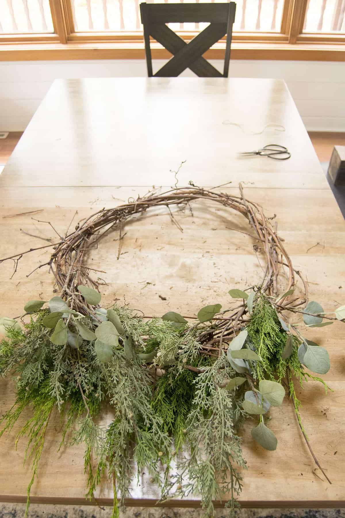 Are you looking for an affordable Christmas wreath? Make your own! Click for a tutorial on how to make a DIY Christmas grapevine wreath. #christmaswreath