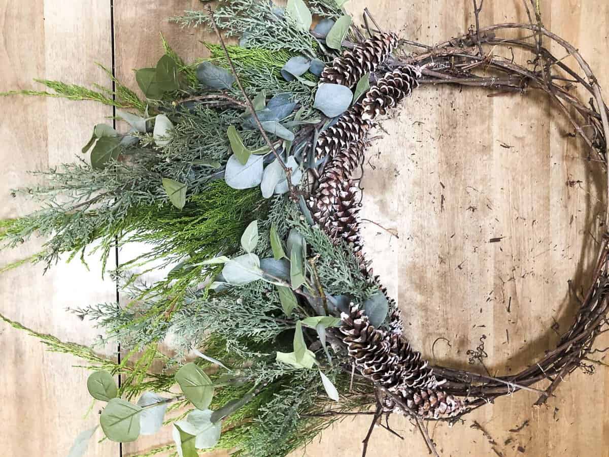 Are you looking for an affordable Christmas wreath? Make your own! Click for a tutorial on how to make a DIY Christmas grapevine wreath. #christmaswreath