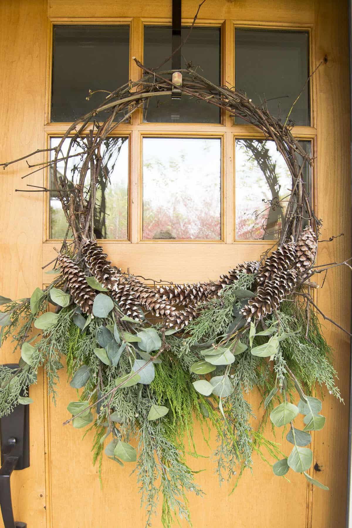 Are you looking for an affordable Christmas wreath? Make your own! Click for a tutorial on how to make a DIY Christmas grapevine wreath. #christmaswreath