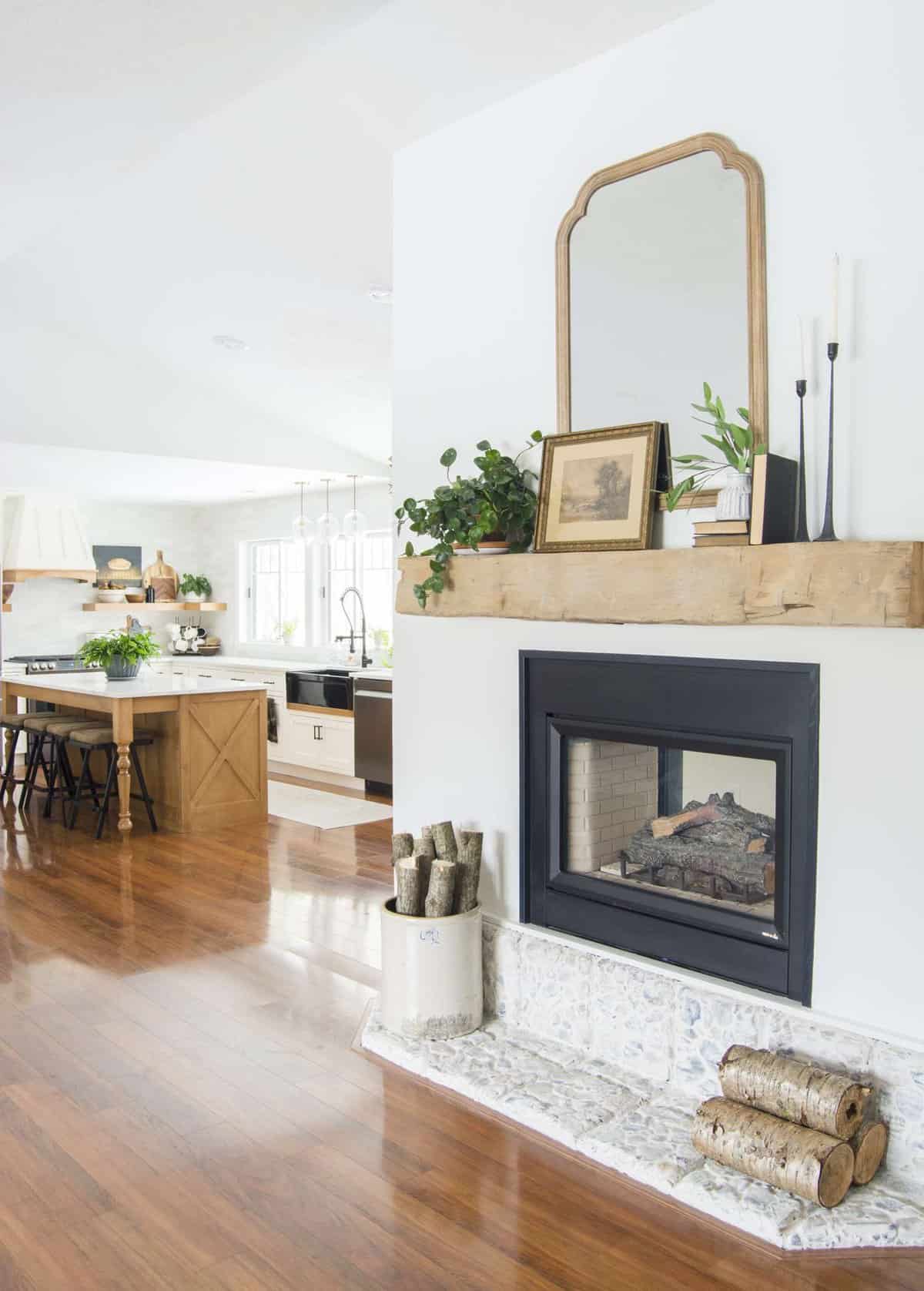 Barn beam mantel styled with modern farmhouse mantel decor.