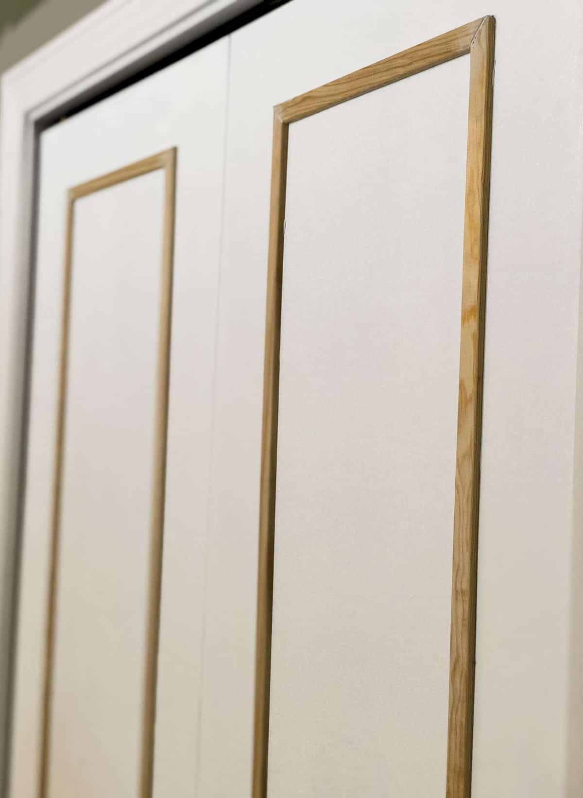 How to add wood trim to bi-fold closet doors to create custom closet doors.