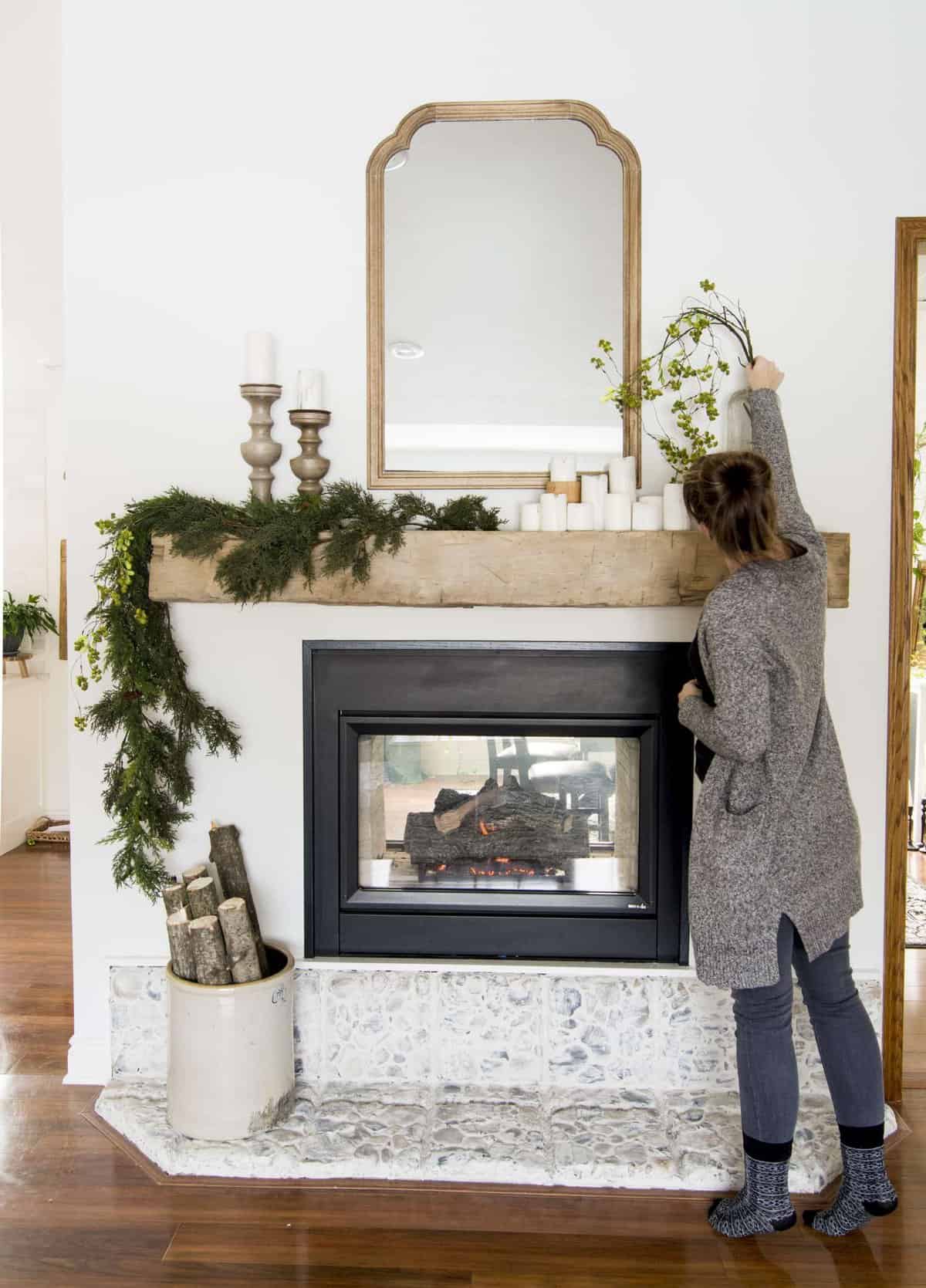 Modern farmhouse mantel decor on a barn beam mantel.