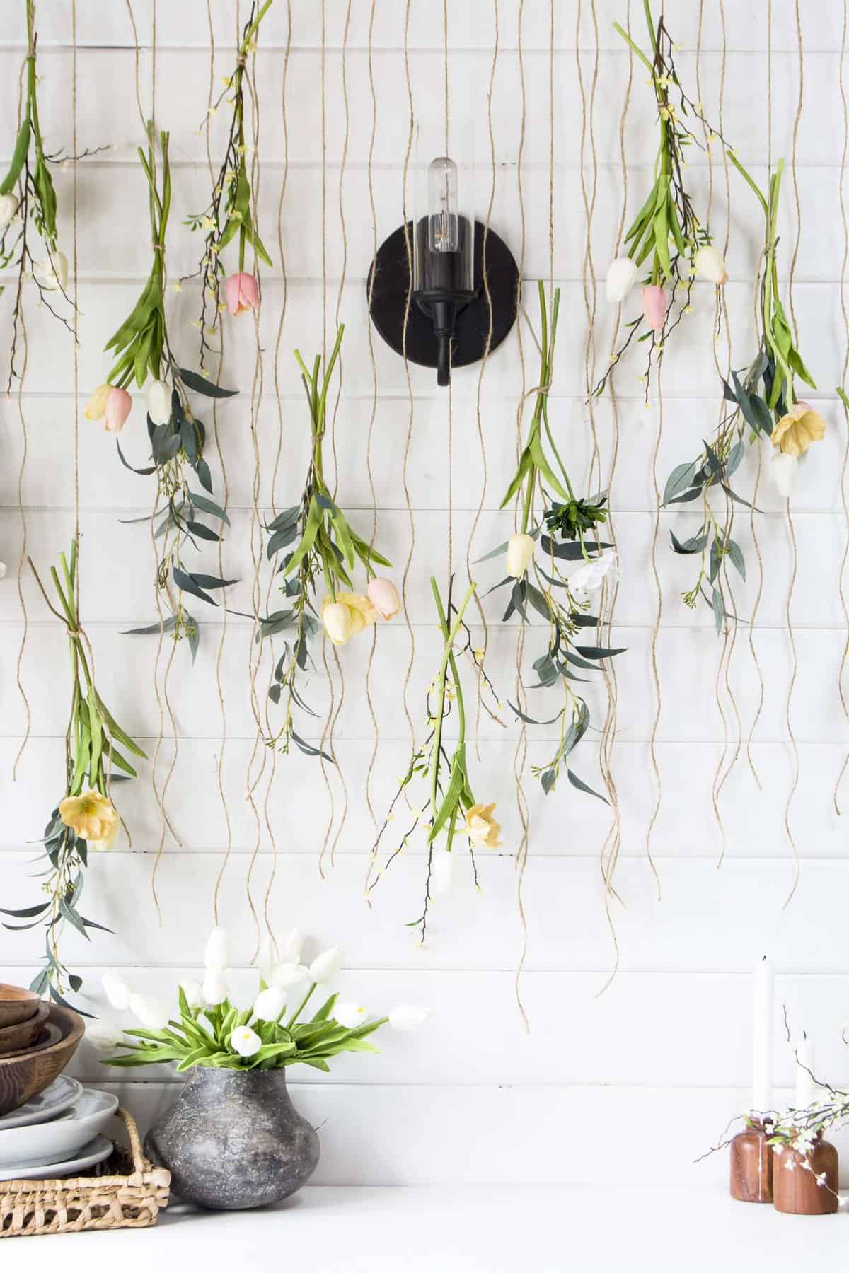 hanging vases with yellow flowers for wedding line backdrop. hung