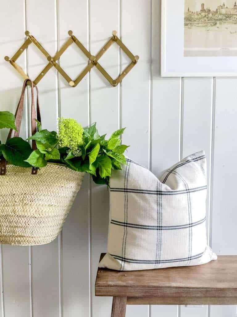 Pillow and basket in an entryway.