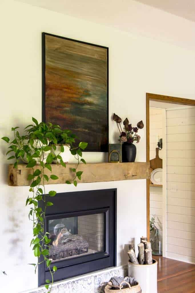 Fall artwork over a fireplace.