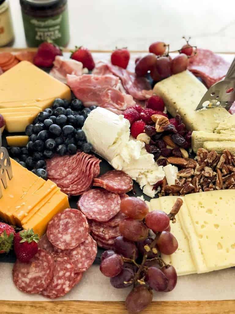 Fruit on a meat and cheese board.