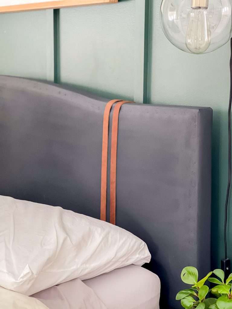 Leather strips on a painted headboard.