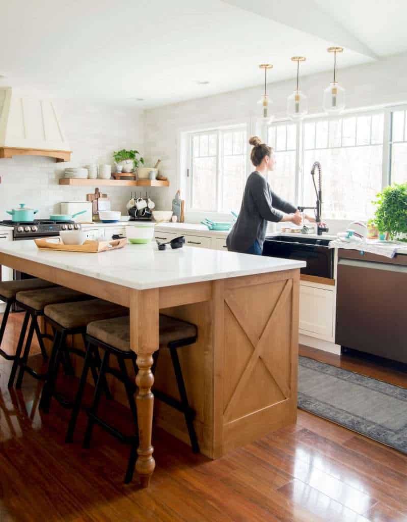 Woman washing dishes in a beautiful kitchen