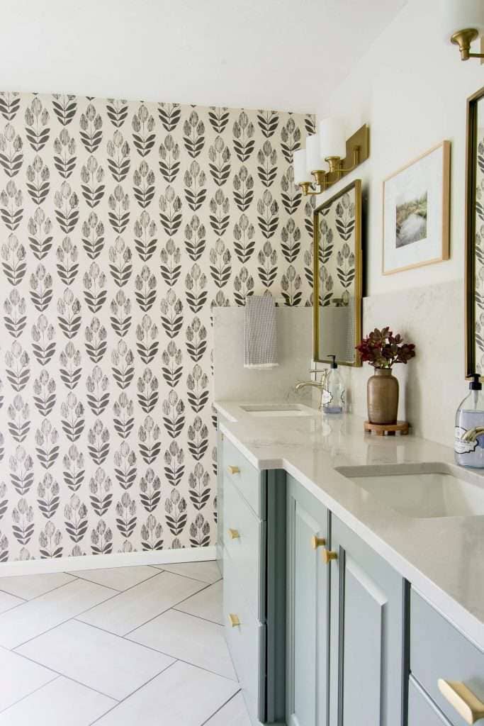 Bathroom vanity with wallpaper.