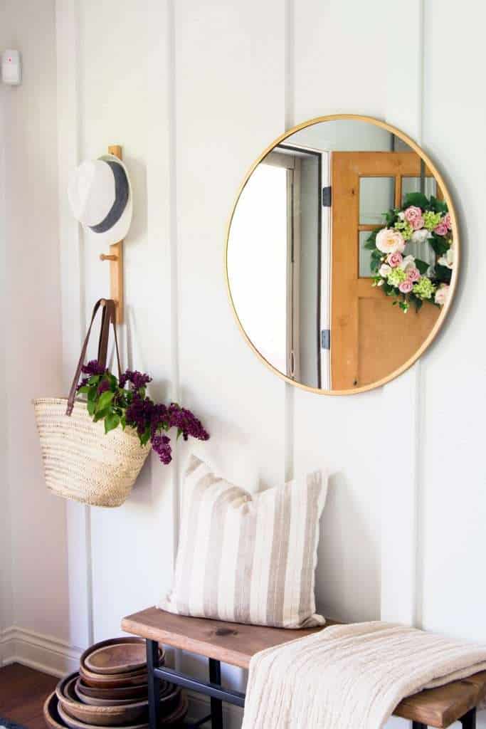 Floor to ceiling board and batten entryway with mirror and decor