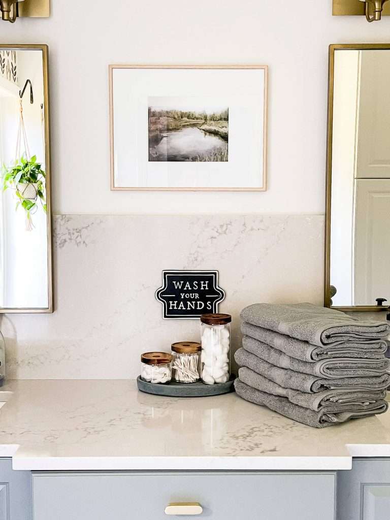 Bath towels and canister set on quartz countertop