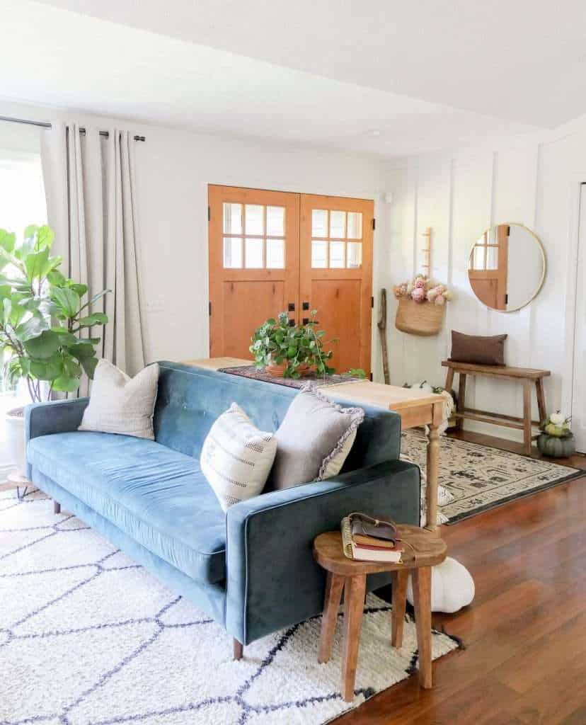 Green velvet sofa in a living room.