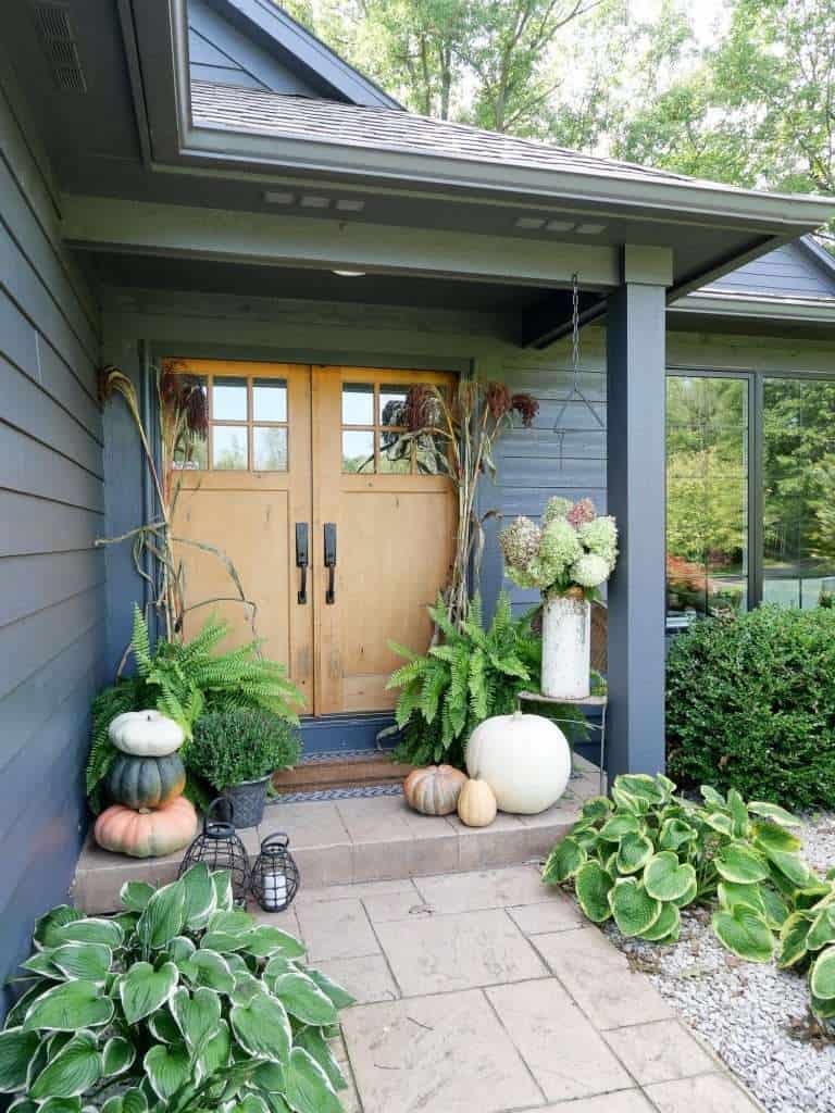 Front porch cozy outdoor space decorated for fall.