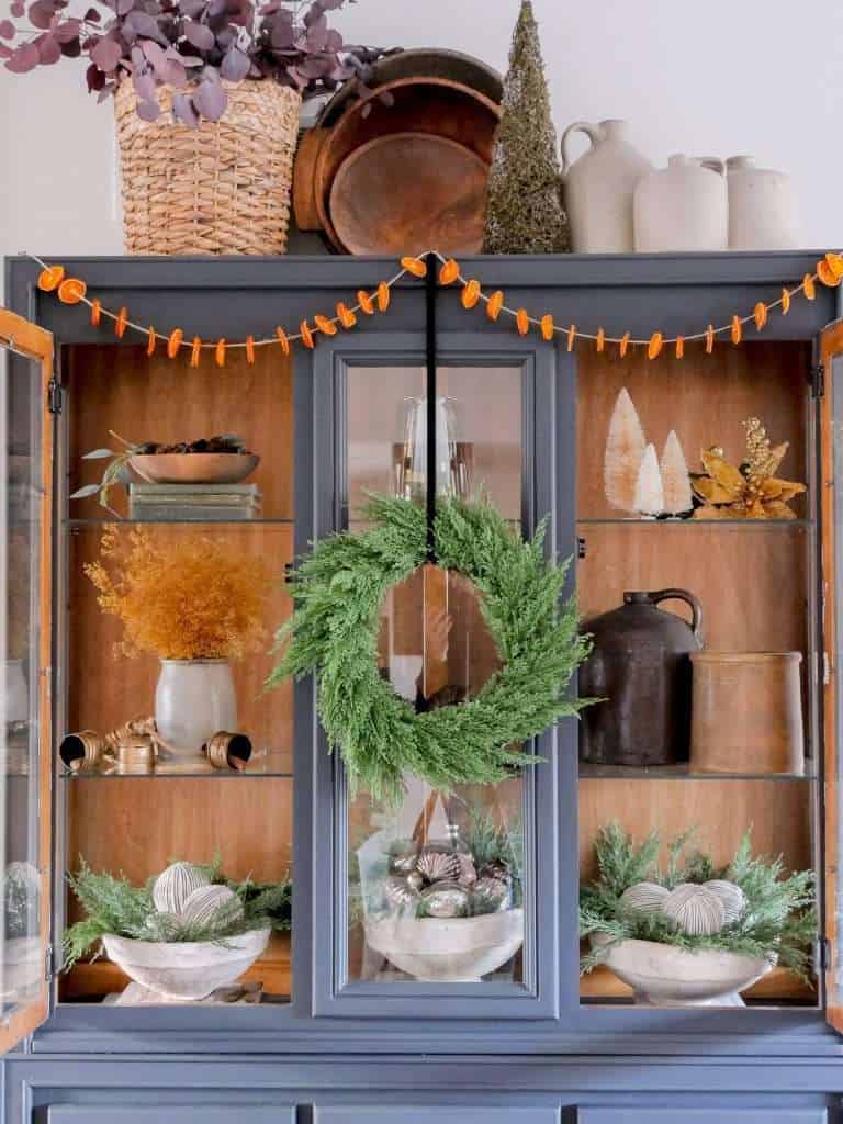 China cabinet with Christmas decor.