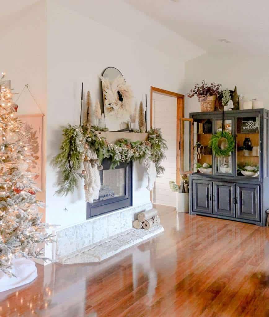 Double sided fireplace mantel with Christmas garland.