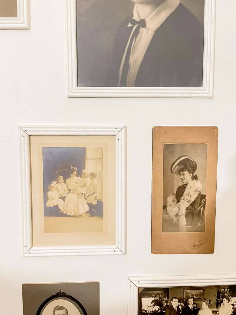 Frame details in an antique photo gallery wall.