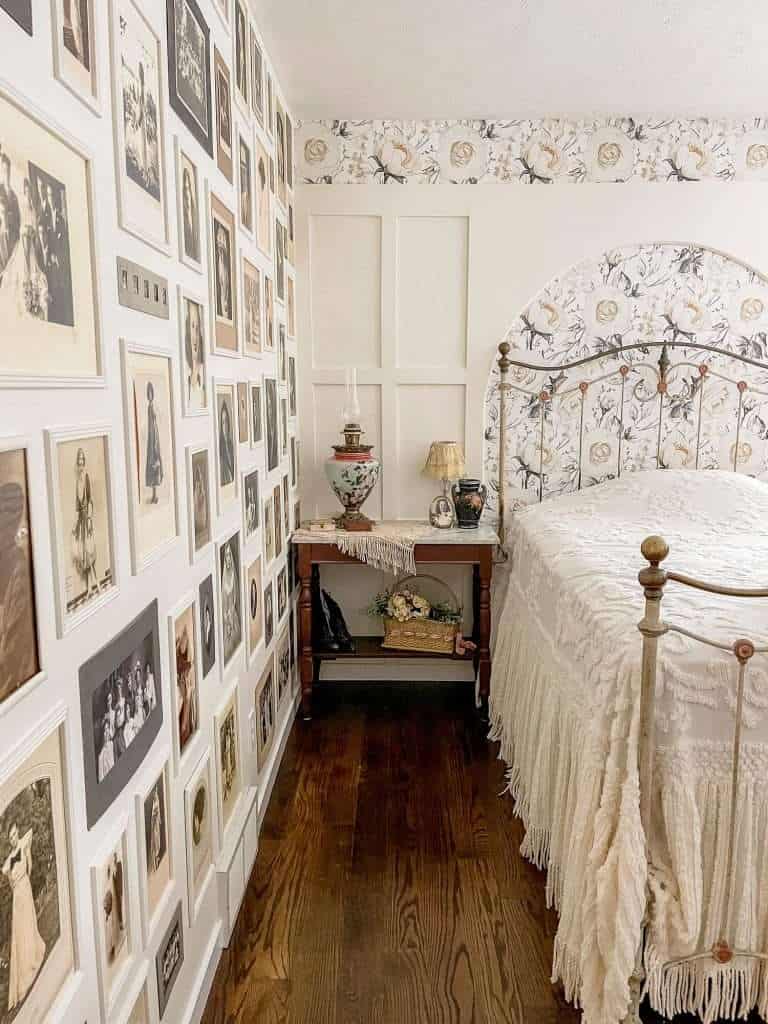 Antique photos in a bedroom gallery wall.