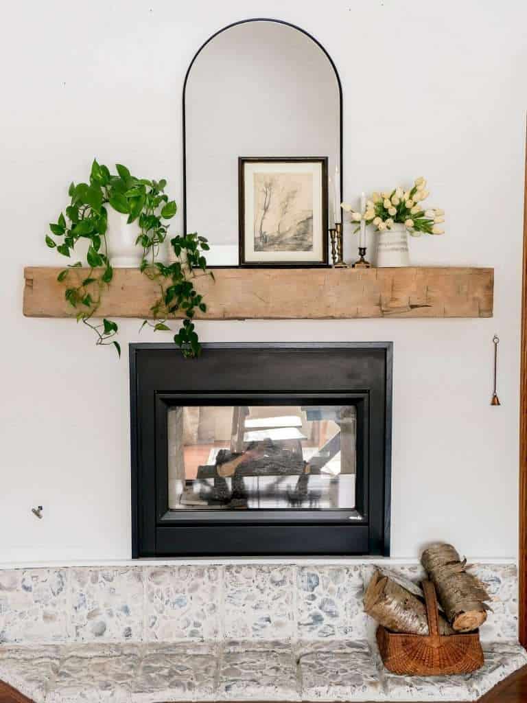 Spring mantel decorating ideas with a barn beam mantel.