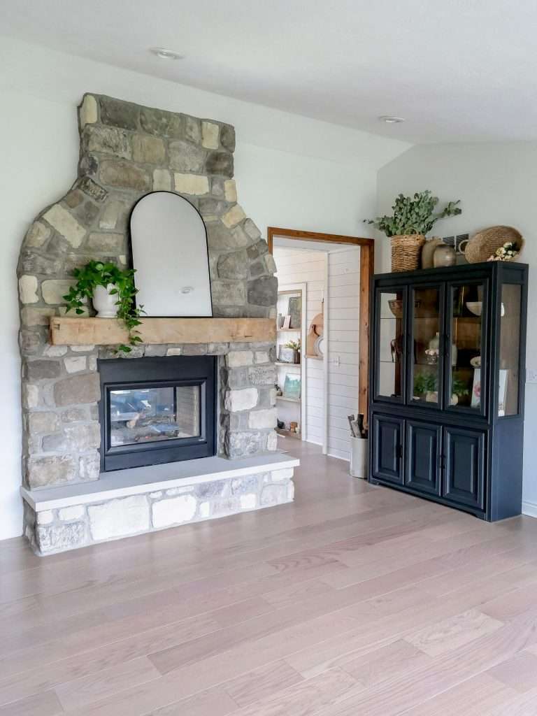 Engineered hardwood with a large stone fireplace.