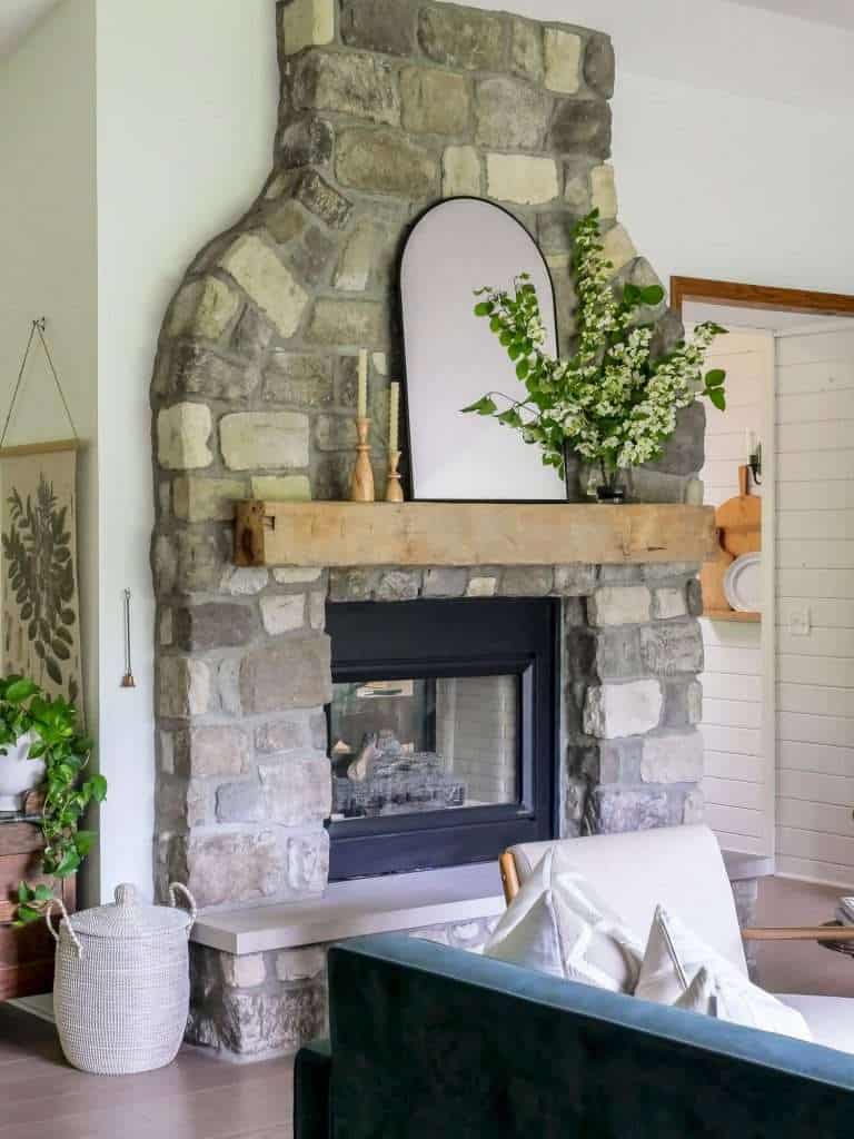 Summer mantel decorating ideas with a stone fireplace.