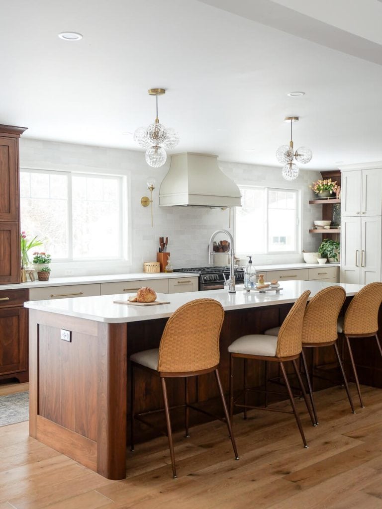 Large kitchen island with walnut cabinets.