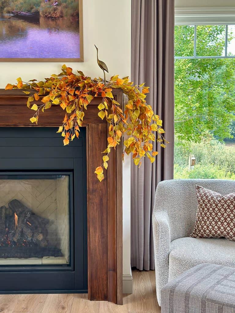 Fall foliage draped on a mantel.