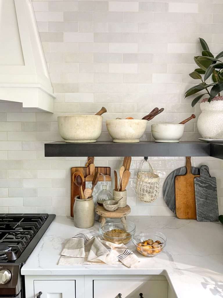 Kitchen shelves and countertop with pear dishes.