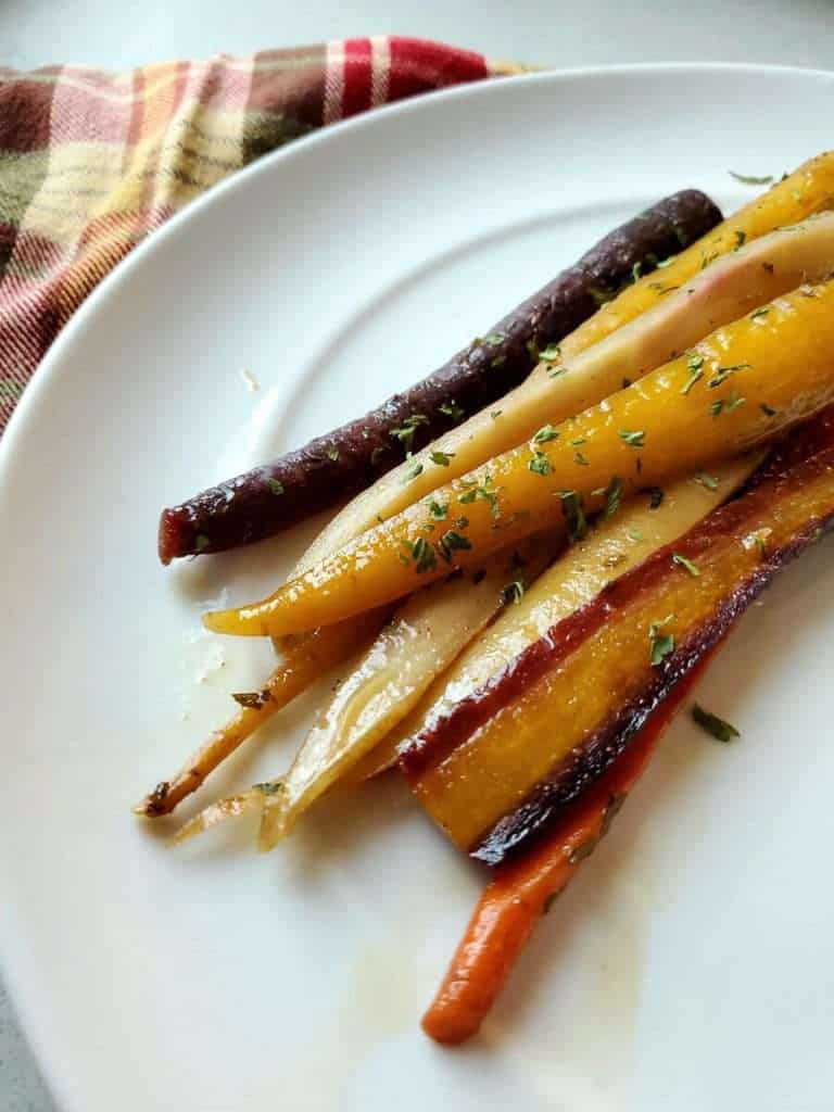Roasted tri color carrots recipe on a plate.