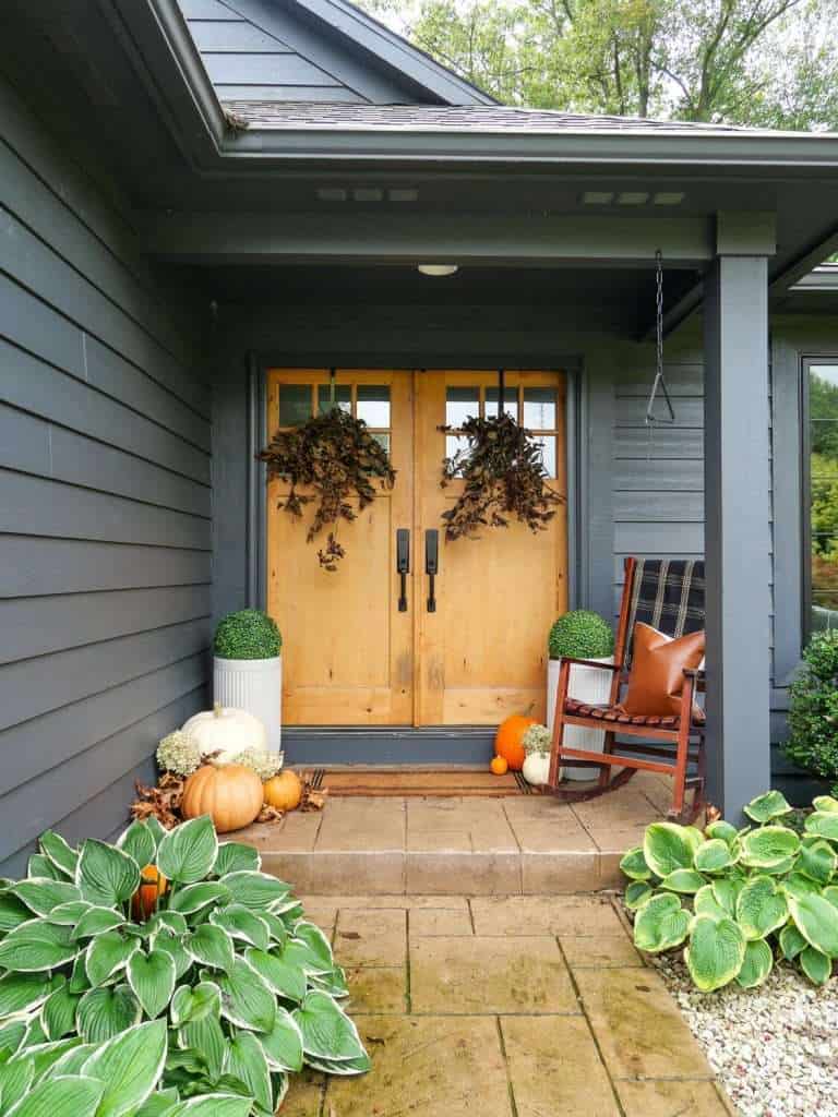 A small front porch decorated for fall.