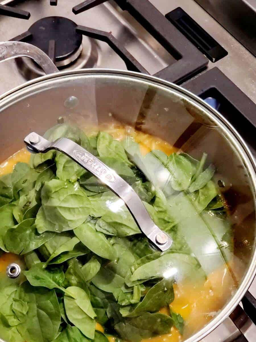 Cooking spinach in a pot.