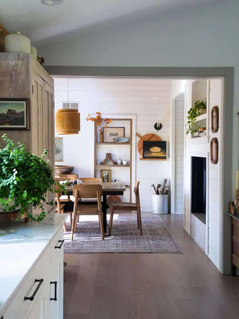 Dining room table next to a wall niche.