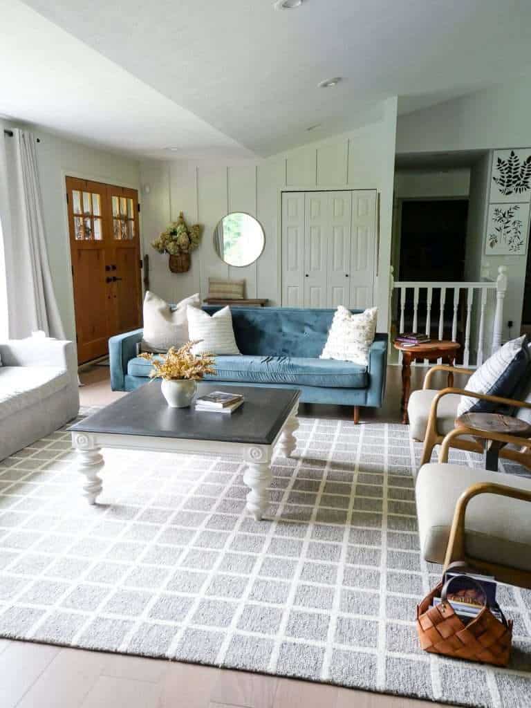 Entryway and living room with checkered rug