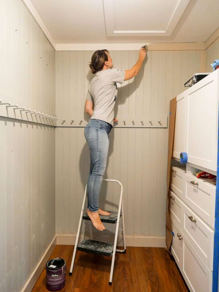 Painting trim in a mudroom.