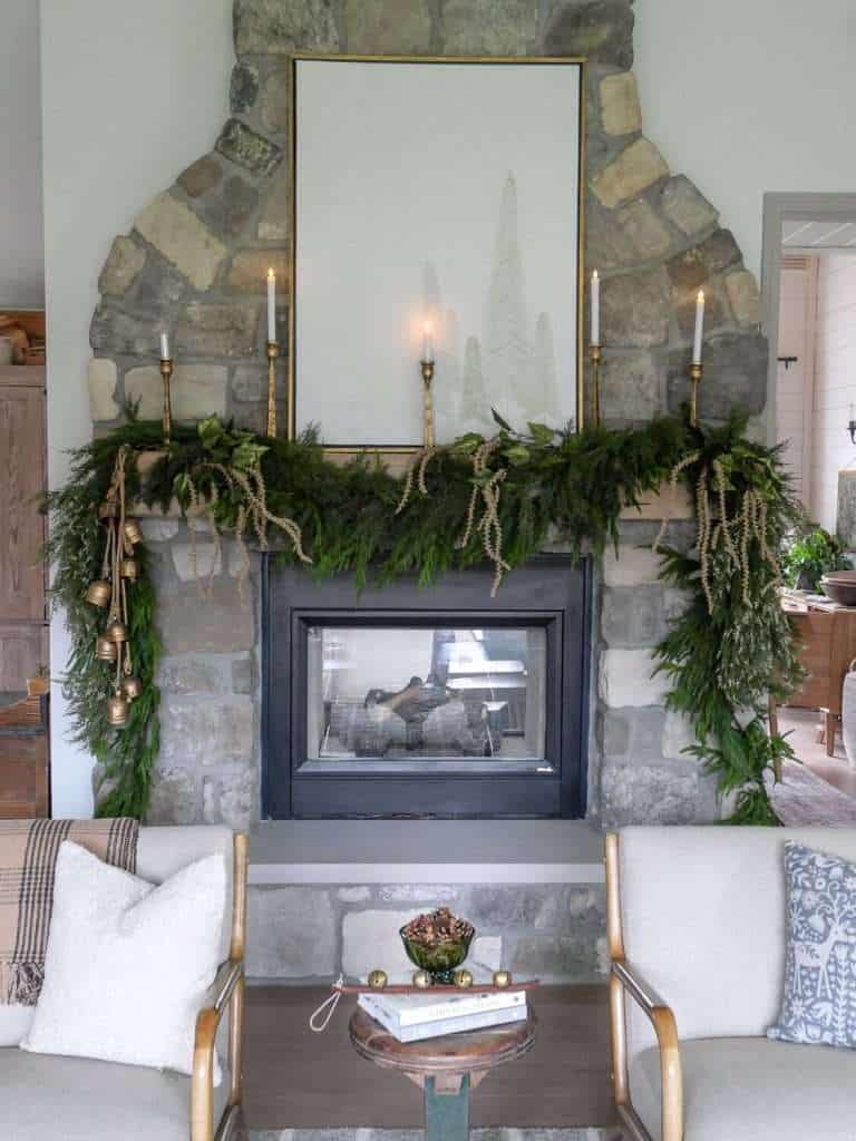 Decorating a Christmas mantel with taper candles.