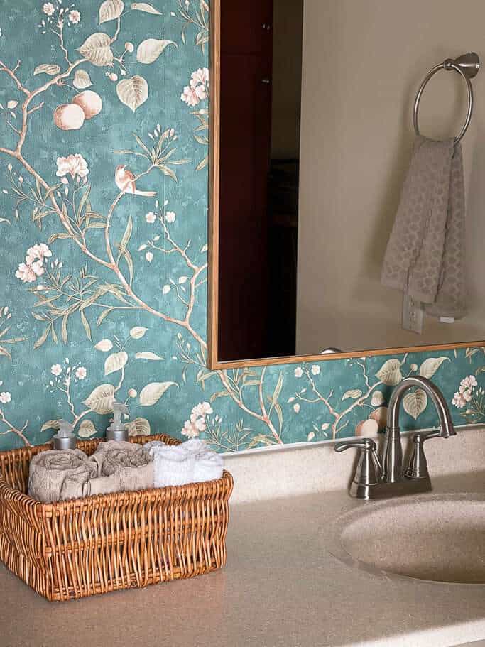 Basket of towels on a bathroom countertop.