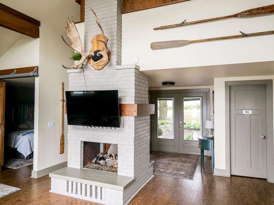 Brick fireplace looking into an Airbnb entryway.