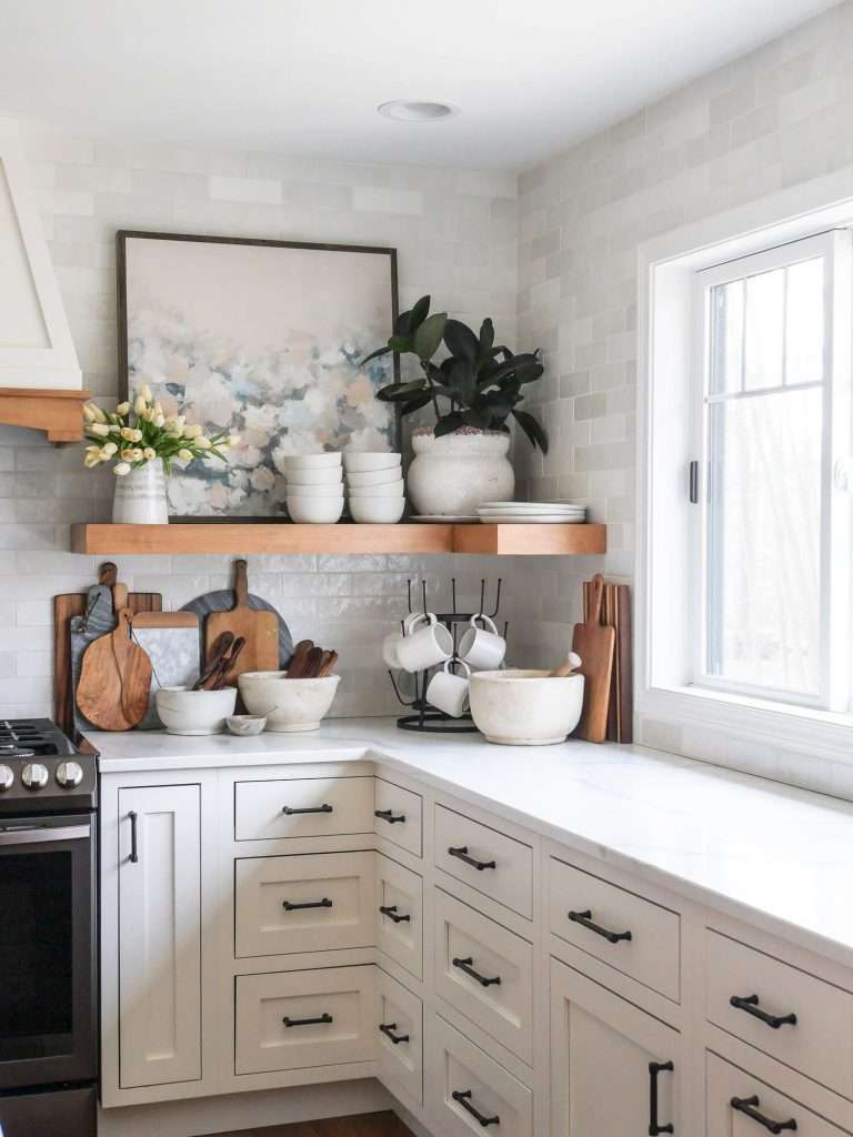 White quartz countertops in a kitchen with open shelving.