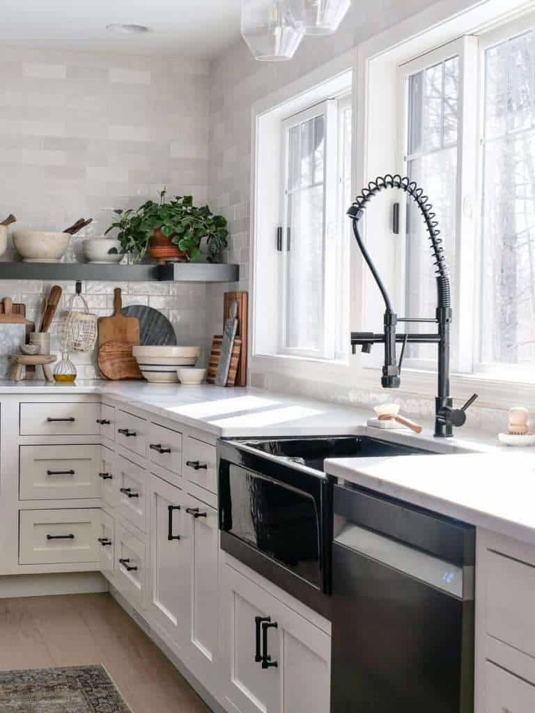 Black apron sink in a kitchen.