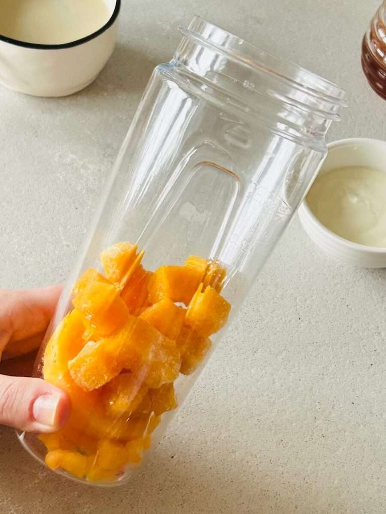Cubed mango in a blender.