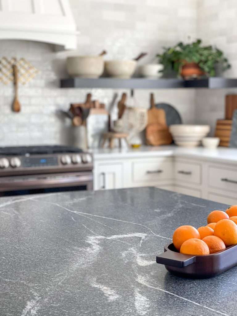 Granite countertop with oranges.