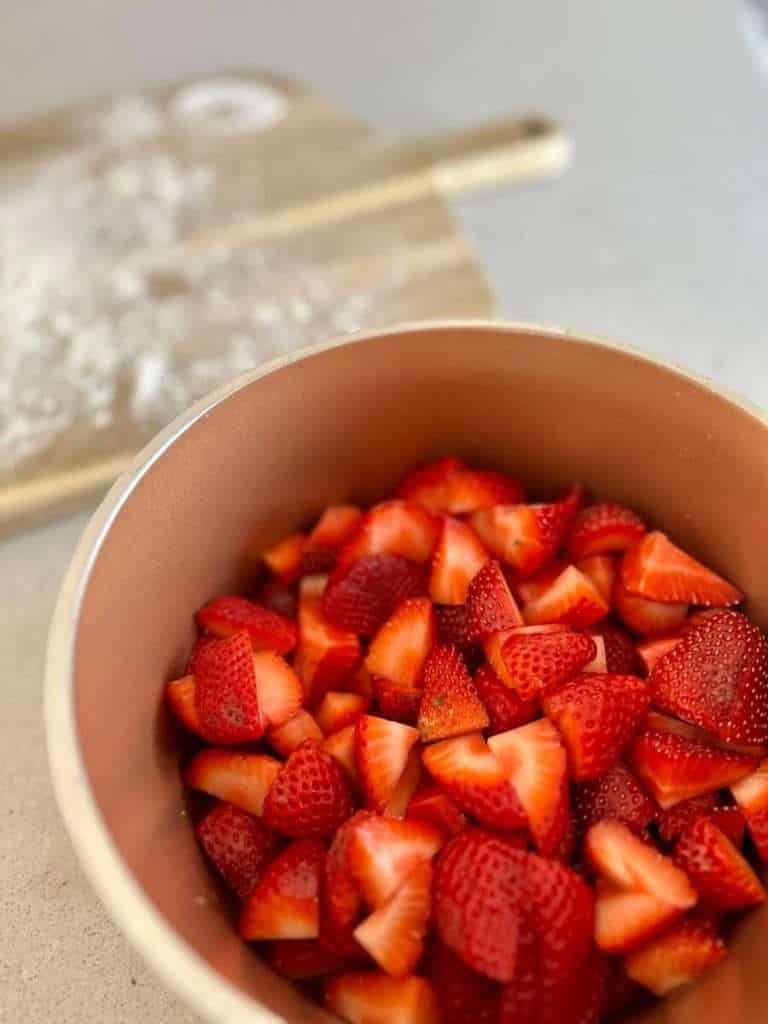 Diced strawberries in a pot.