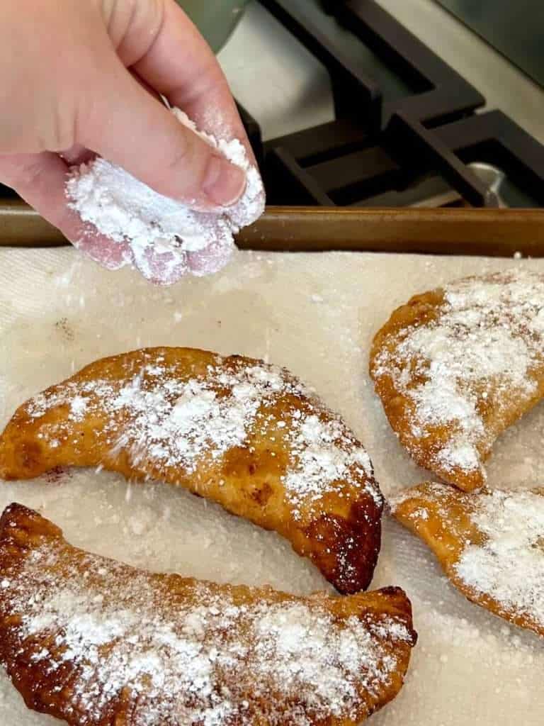 Fried pastries sprinkled with sugar.