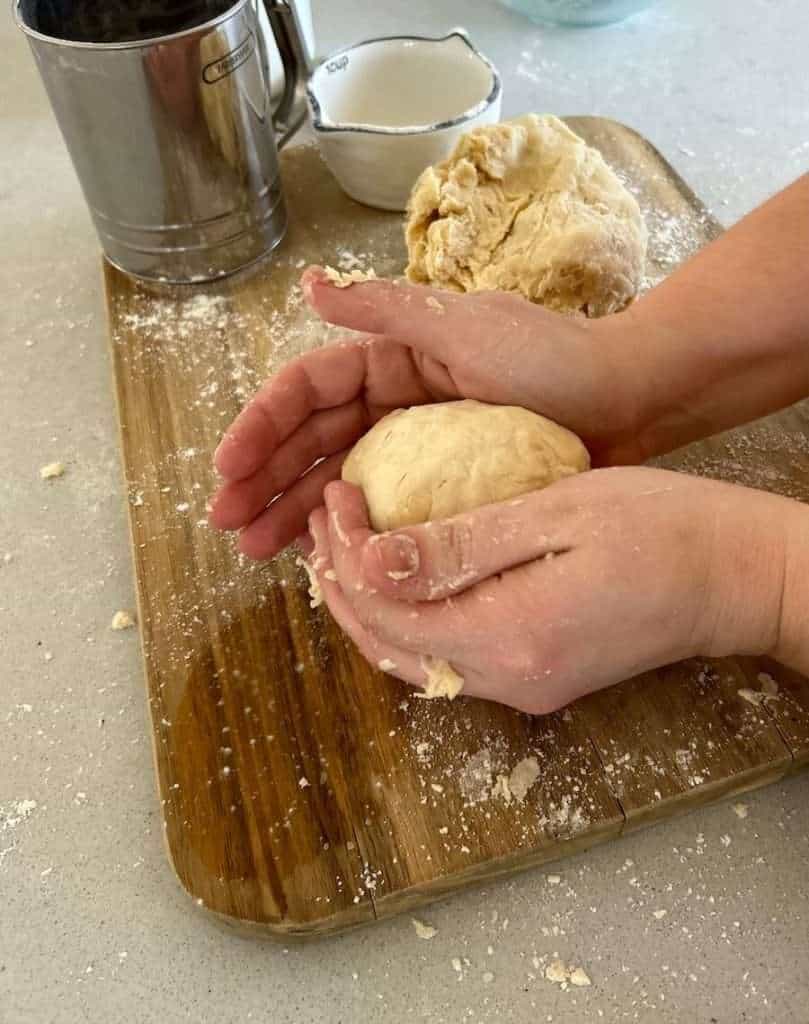 Mixing dough with hands.