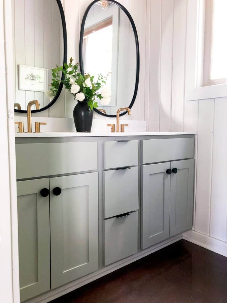 Bathroom vanity with painted cabinets.