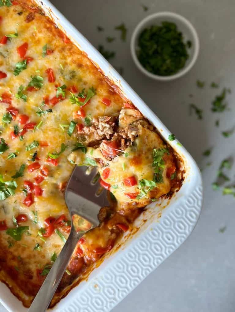 Serving Mexican zucchini lasagna from a 9x13 dish.