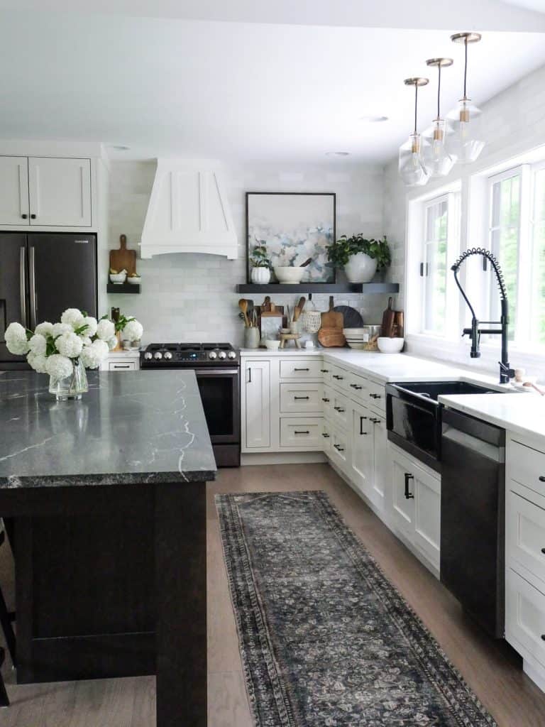 White kitchen with a dark island.