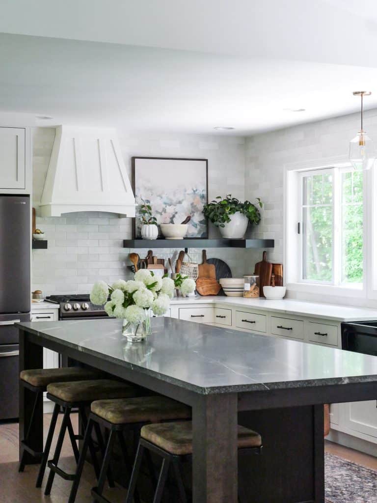 White kitchen with a dark island.